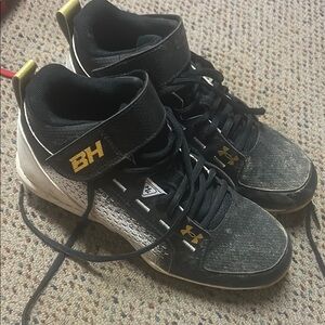 Under Armour Black and Gold Cleats with Lace-Up Design